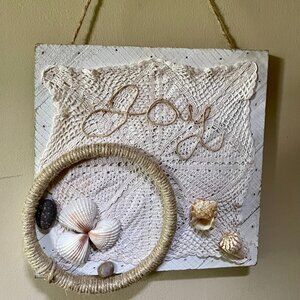 Artisan made wooden "JOY" sign with an ocean sea side vibe